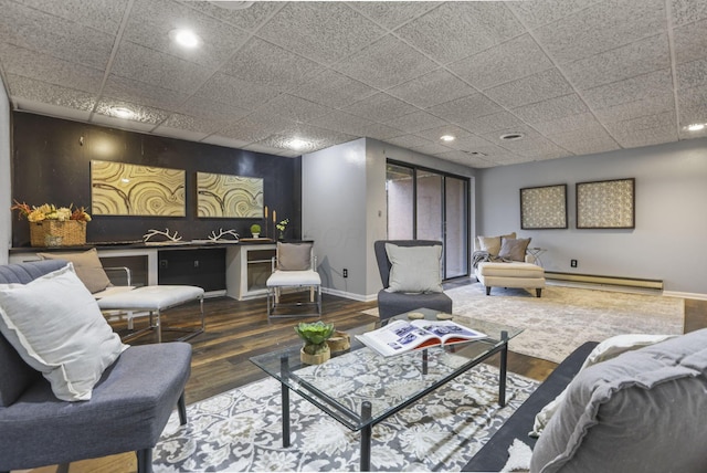 living room featuring recessed lighting, a baseboard heating unit, and baseboards