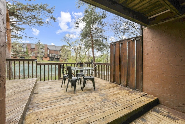 wooden terrace with outdoor dining space