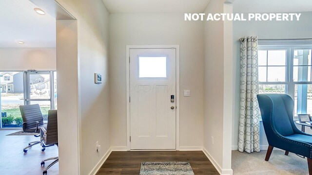 foyer entrance with dark wood-type flooring, baseboards, and recessed lighting