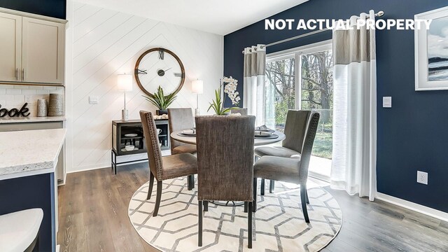 dining room featuring light wood-style flooring and baseboards