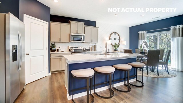 kitchen with wood finished floors, light countertops, visible vents, and stainless steel appliances