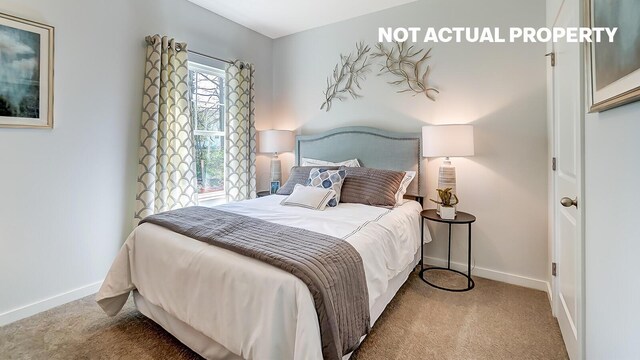carpeted bedroom featuring baseboards