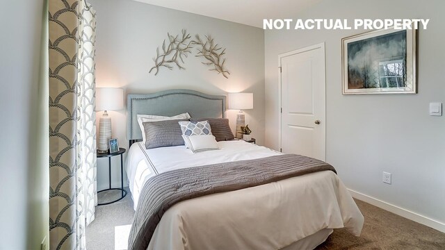 carpeted bedroom featuring baseboards