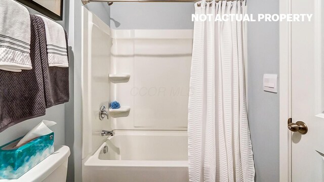 full bathroom featuring shower / bath combo and toilet