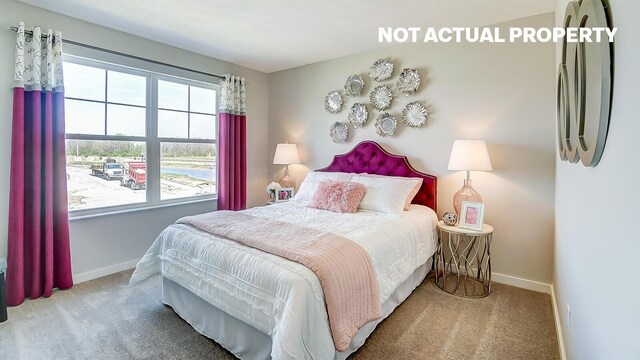 carpeted bedroom featuring baseboards