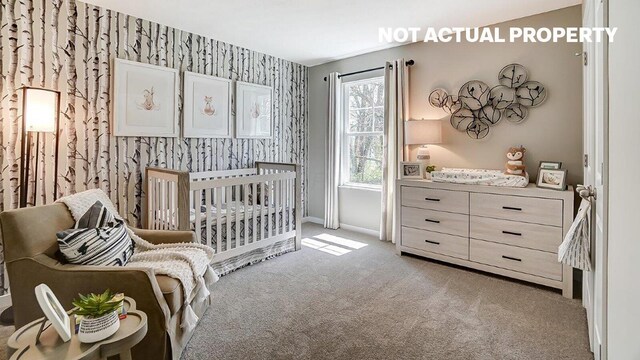 carpeted bedroom with baseboards, wallpapered walls, and a nursery area