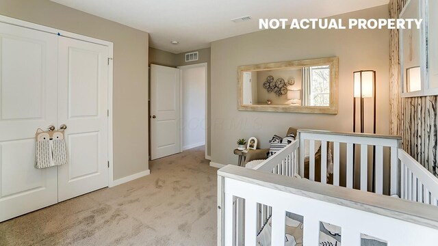carpeted bedroom featuring a closet, baseboards, visible vents, and a nursery area