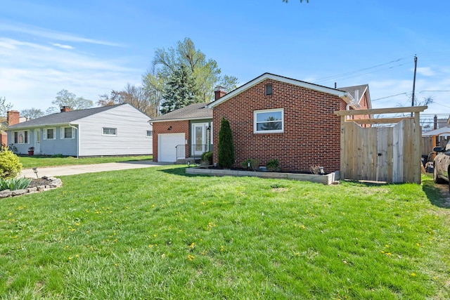 2209 Fishinger Rd, Columbus, OH 43221 - view of front of home with fence, an attached garage, brick siding, a front yard, and driveway
