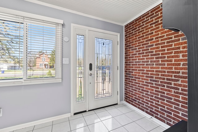 2209 Fishinger Rd, Columbus, OH 43221 - foyer entrance with light tile patterned flooring, brick wall, plenty of natural light, and baseboards
