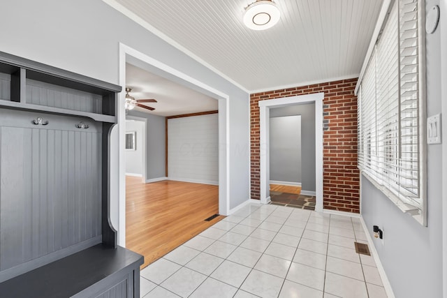2209 Fishinger Rd, Columbus, OH 43221 - mudroom featuring baseboards, brick wall, visible vents, and ceiling fan