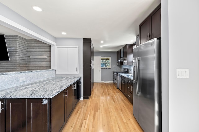 2209 Fishinger Rd, Columbus, OH 43221 - kitchen with dark brown cabinets, appliances with stainless steel finishes, tasteful backsplash, and light wood-type flooring