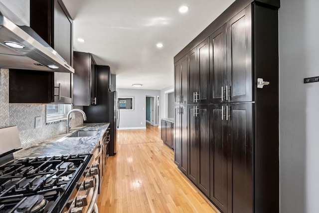 2209 Fishinger Rd, Columbus, OH 43221 - kitchen featuring light stone countertops, wall chimney exhaust hood, stainless steel appliances, baseboards, and light wood-type flooring