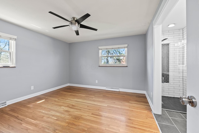 2209 Fishinger Rd, Columbus, OH 43221 - unfurnished room featuring baseboards, plenty of natural light, and visible vents