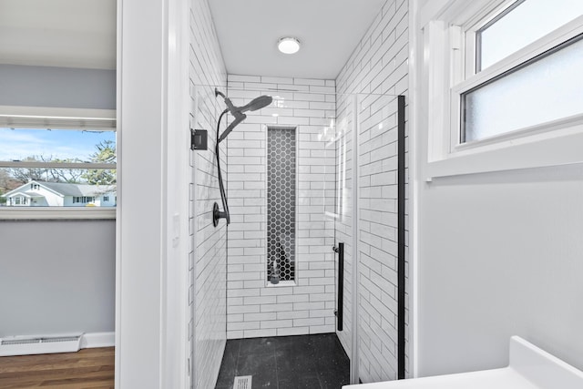 2209 Fishinger Rd, Columbus, OH 43221 - bathroom featuring plenty of natural light, a stall shower, and baseboard heating