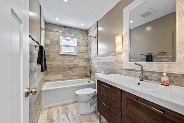 2209 Fishinger Rd, Columbus, OH 43221 - bathroom with vanity, toilet, tile walls,  shower combination, and visible vents