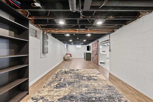 2209 Fishinger Rd, Columbus, OH 43221 - unfinished basement featuring wood finished floors, electric panel, and concrete block wall