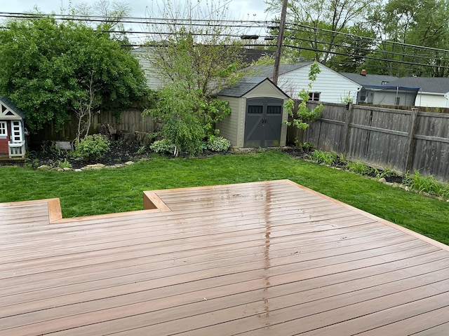 2209 Fishinger Rd, Columbus, OH 43221 - wooden terrace with an outdoor structure, a fenced backyard, a yard, and a storage shed