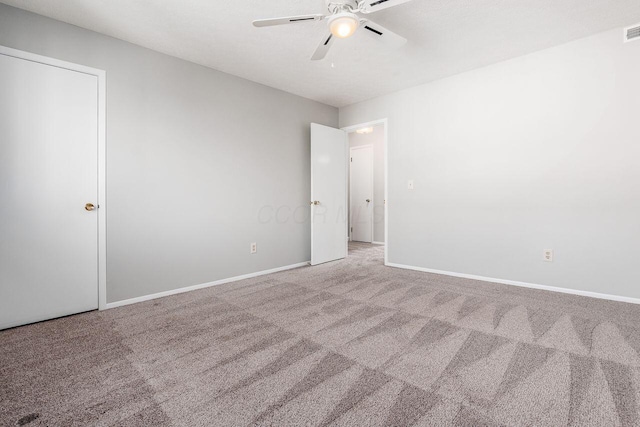unfurnished bedroom featuring ceiling fan, carpet floors, visible vents, and baseboards