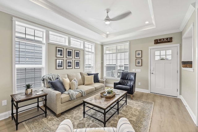 living area featuring a healthy amount of sunlight, light wood finished floors, and ceiling fan