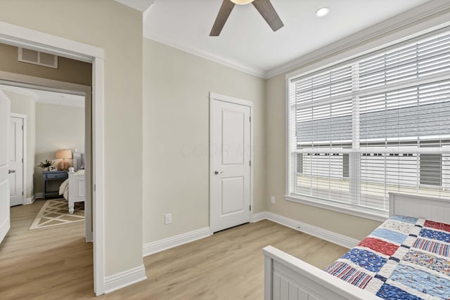 bedroom with visible vents, light wood-style flooring, and baseboards