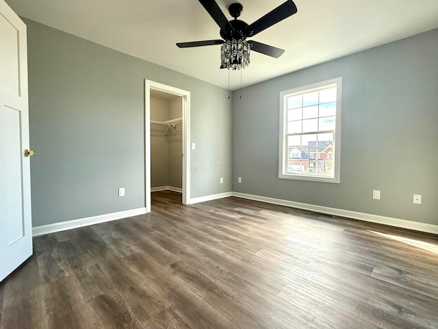 9465 Santa Clara Cir, Plain City, OH 43064 - unfurnished bedroom with dark wood-style flooring, a ceiling fan, baseboards, a spacious closet, and a closet