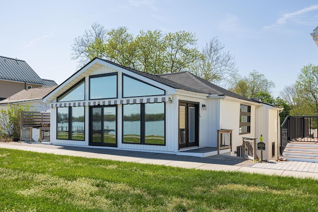 rear view of property with a lawn and a wooden deck