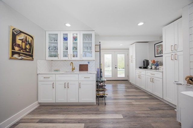 kitchen with recessed lighting, glass insert cabinets, tasteful backsplash, white cabinets, and dark wood finished floors