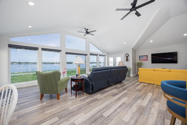 living room featuring light wood finished floors, a ceiling fan, recessed lighting, and vaulted ceiling