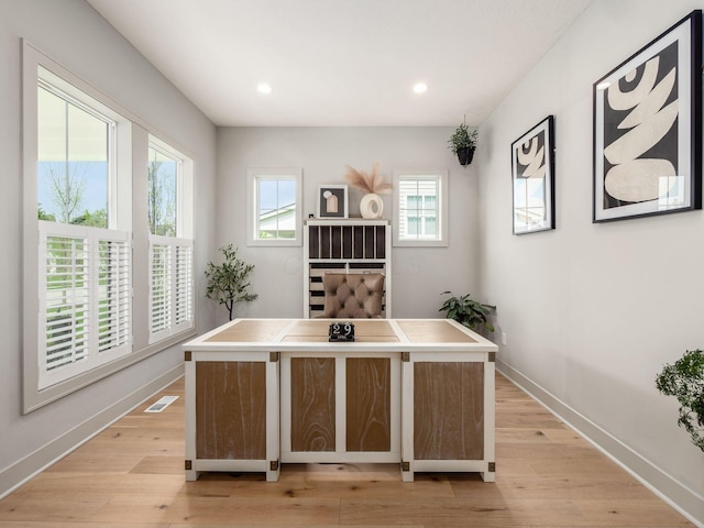 office space with recessed lighting, baseboards, light wood-type flooring, and visible vents