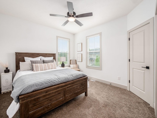 carpeted bedroom with a ceiling fan and baseboards