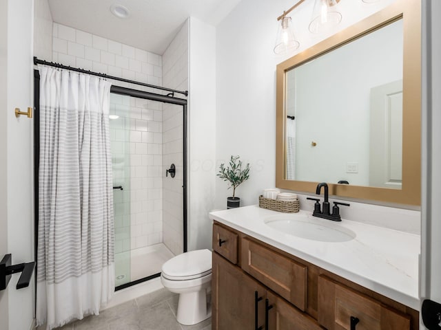 full bath with vanity, tile patterned flooring, a stall shower, and toilet