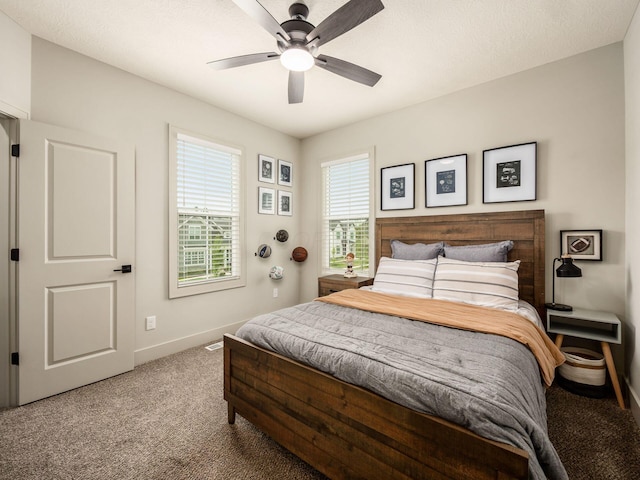 carpeted bedroom featuring baseboards and ceiling fan