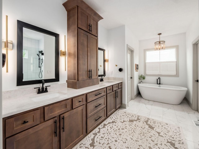 full bathroom with a soaking tub, a chandelier, a sink, and marble finish floor