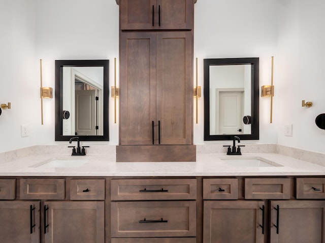 full bathroom featuring double vanity and a sink