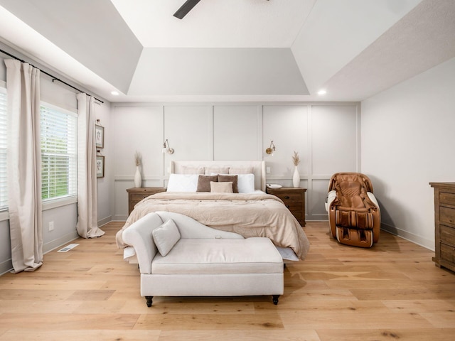 bedroom with recessed lighting, visible vents, light wood-style flooring, and lofted ceiling