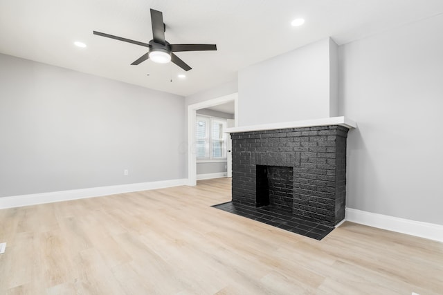 271 S Terrace Ave, Columbus, OH 43204 - unfurnished living room with light wood-style flooring, ceiling fan, baseboards, and a brick fireplace