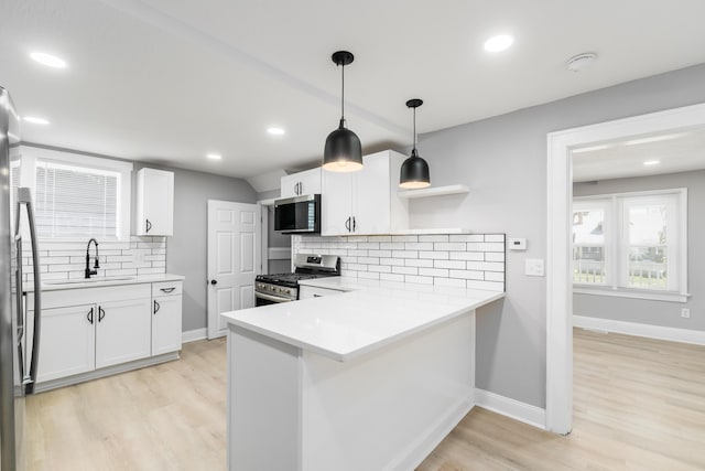 271 S Terrace Ave, Columbus, OH 43204 - kitchen featuring appliances with stainless steel finishes, light wood finished floors, a sink, and white cabinetry