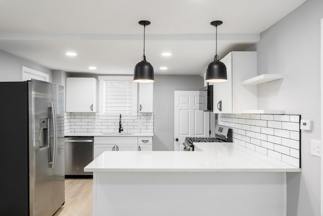 271 S Terrace Ave, Columbus, OH 43204 - kitchen with a peninsula, open shelves, a sink, stainless steel appliances, and light wood finished floors