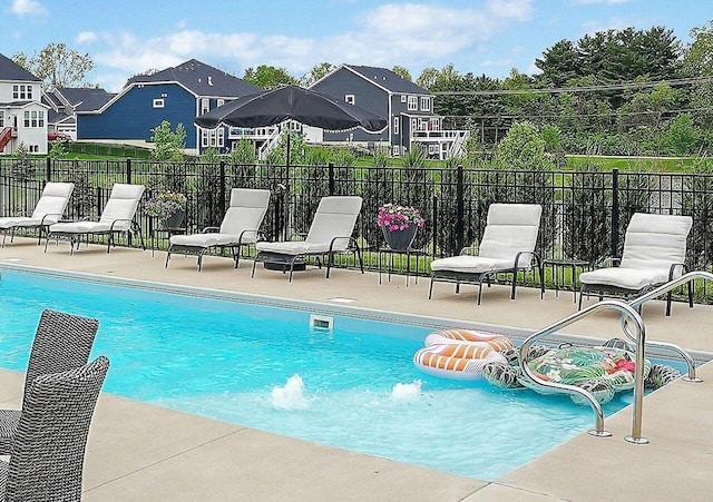 pool featuring fence and a patio