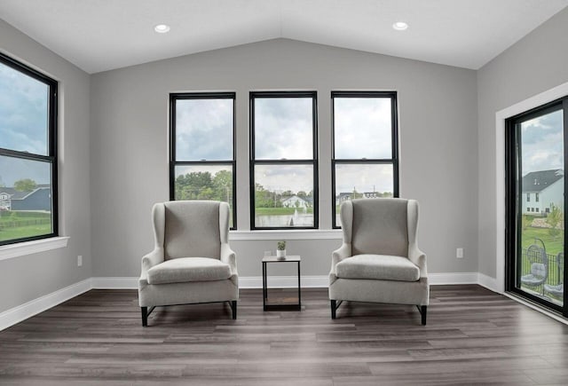 sitting room with baseboards, wood finished floors, recessed lighting, and vaulted ceiling
