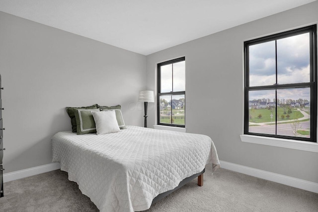 carpeted bedroom featuring baseboards