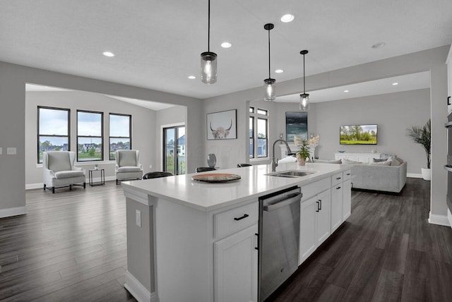 kitchen featuring a sink, open floor plan, stainless steel dishwasher, and dark wood-type flooring