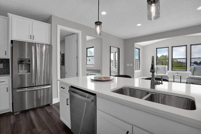 kitchen featuring stainless steel appliances, recessed lighting, a sink, dark wood-type flooring, and light countertops