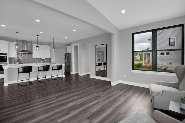 living room with lofted ceiling, baseboards, dark wood-style floors, and recessed lighting