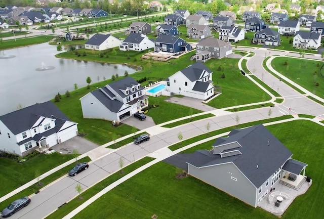 drone / aerial view with a water view and a residential view