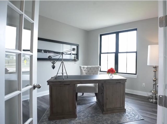 home office featuring baseboards and dark wood finished floors