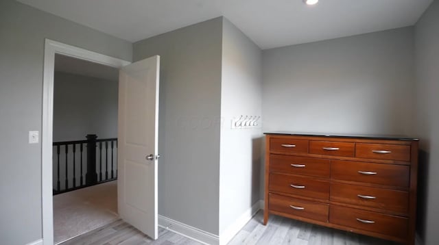 bedroom with baseboards and light wood-style floors