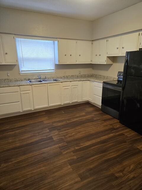 kitchen featuring light countertops, a sink, white cabinetry, and black appliances
