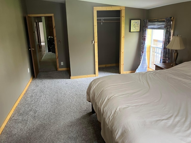 carpeted bedroom with a closet and baseboards