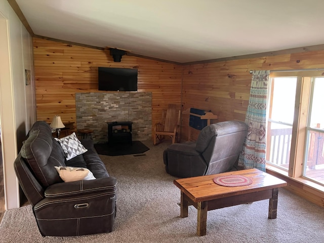 living area featuring wooden walls, vaulted ceiling, and carpet flooring